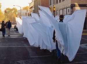 angel action pic-- Angel Walk, Laramie, Wyoming, 1999. Romaine Patterson bringing up the rear with garland on her head