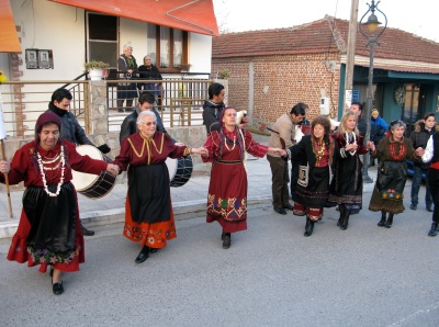 Kyria Fotini holds the flag and leads the dance in Kitros. 