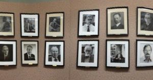 Professors who've made a significant contribution to their field. Three walls, two-deep of white men.