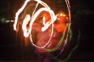 the author spins fire, surrounded by trails of flame light