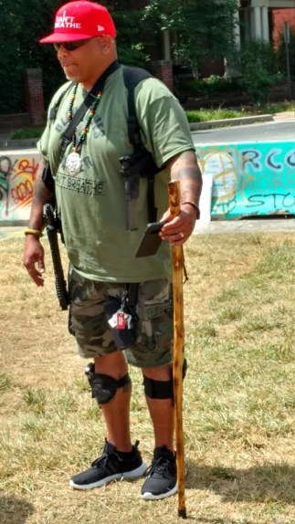 Picture of man is armed to the hilt wearing a hat saying, “I Can’t Breathe.” 