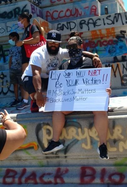 Picture of parents with sign, stating My son will not be your victim